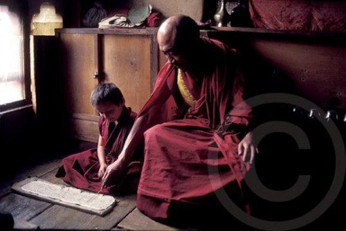 Photo of a monk teaching a child in Bhutan